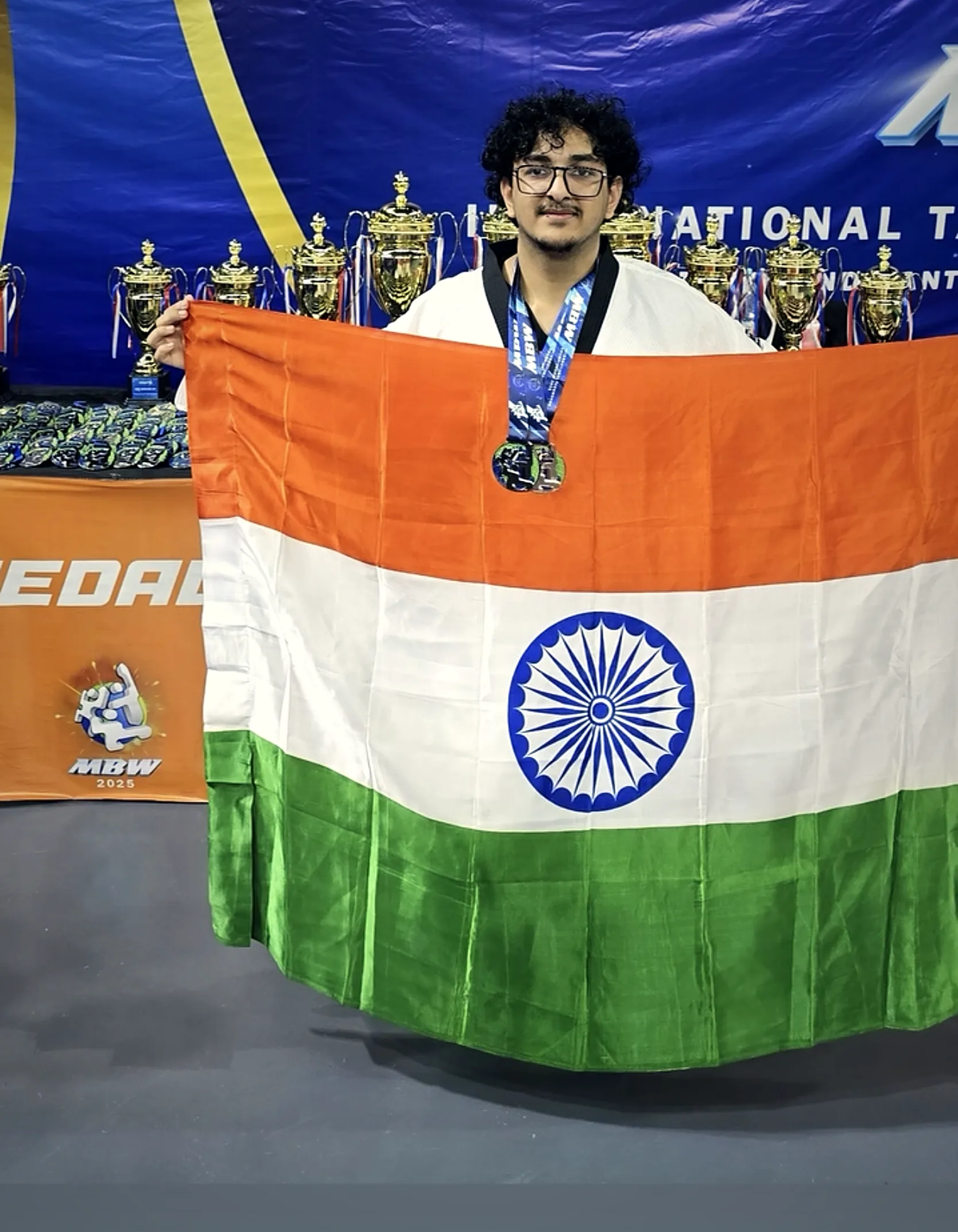 Holding the Indian flag with a medal at MBW 2025