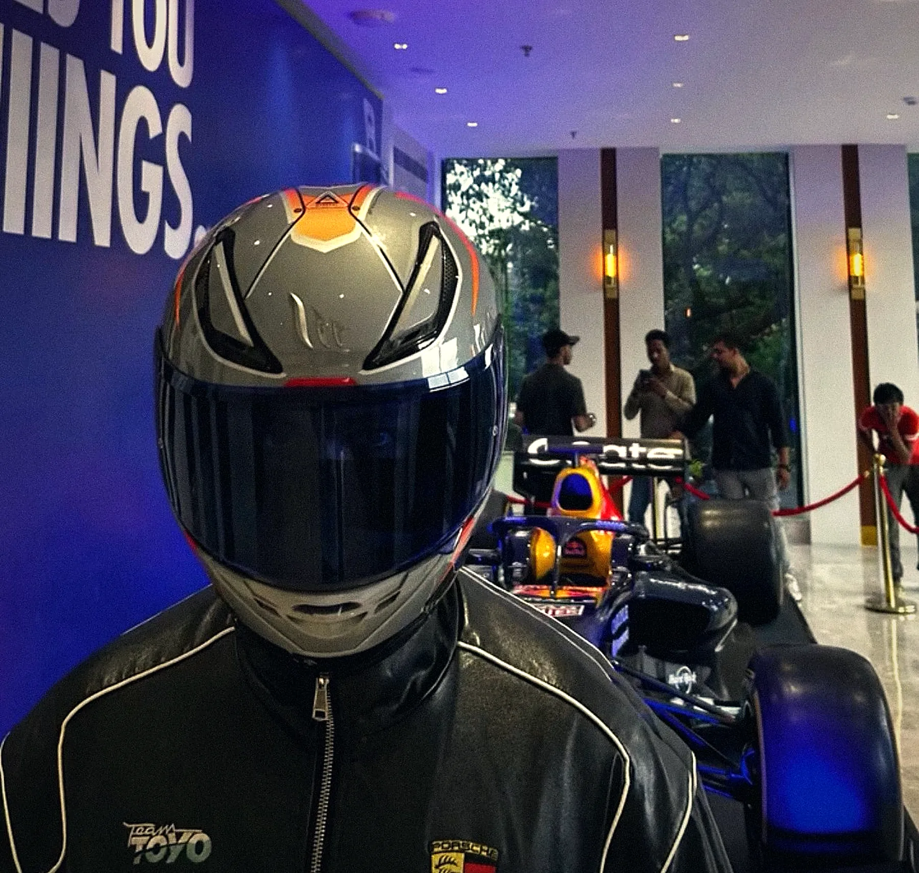 Helmet on beside an F1 show car