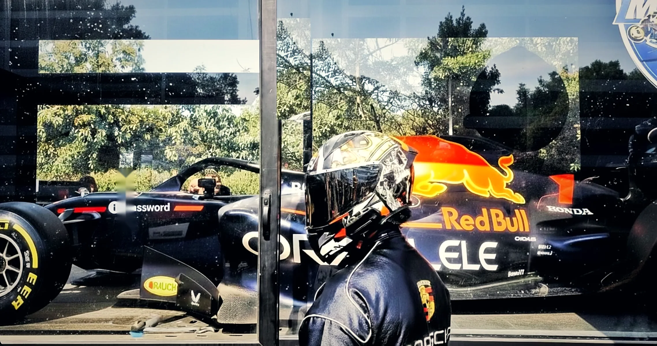 In a racing helmet beside the Red Bull F1 show car