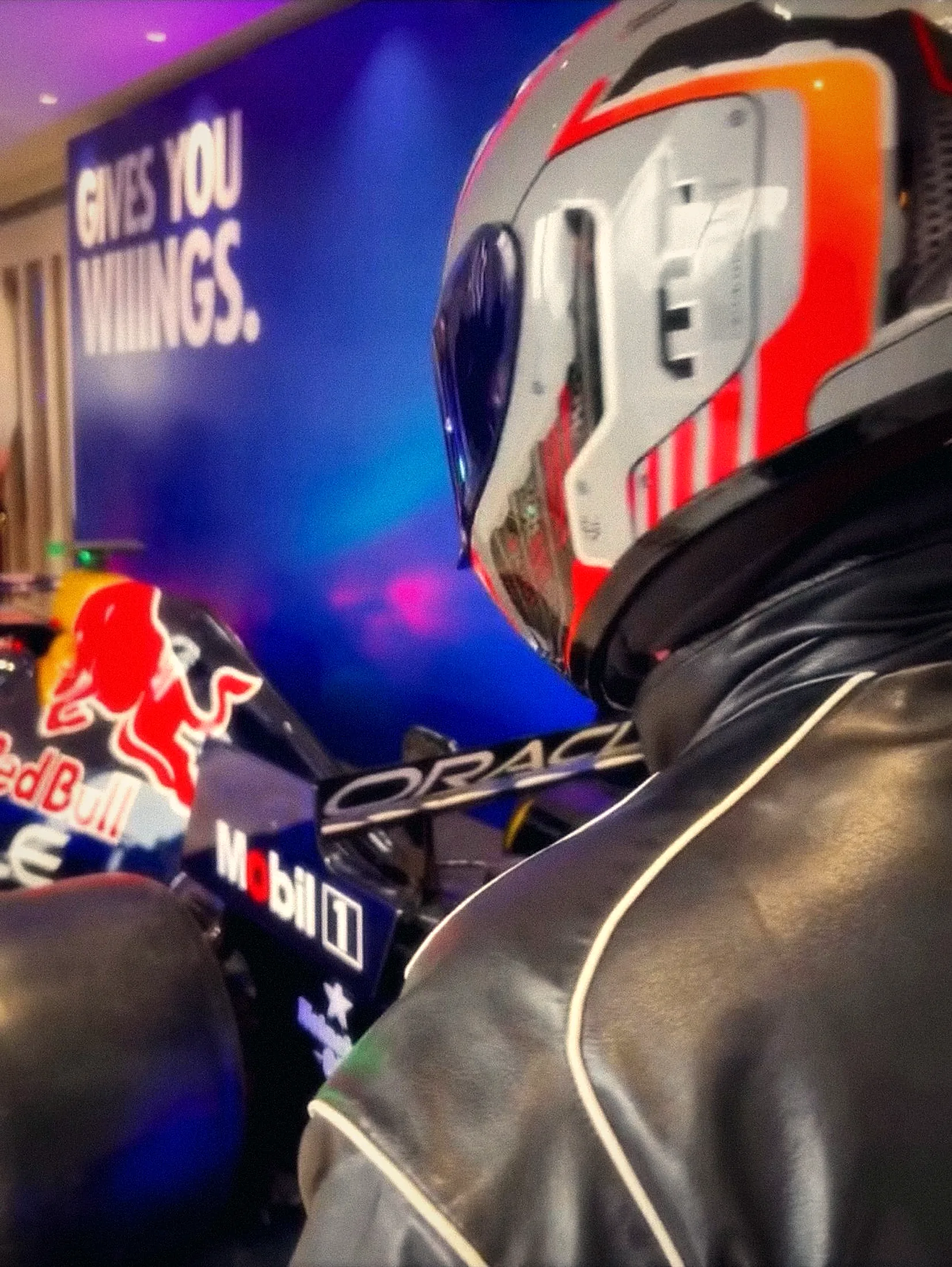 Helmet beside a Red Bull F1 show car